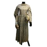 Victorian dress of brocaded coffee silk with cream and brown flowers, tassel detail and leg of