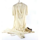 1930's cream silk tennis dress, double breasted, with belt and a visor, together with a pair of fine