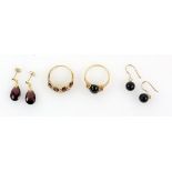 Garnet and diamond dress ring, a pair of faceted tear drop garnet earrings, ruby and onyx ring,