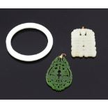 Two jade pendants, a mutton fat colour pendant carved with a bat over a symbol, 9 ct gold mount