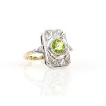 Peridot and diamond panel ring, central round cut peridot, estimated weight 0.78 carats, mounted