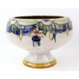 Doulton stoneware bowl with tube lined decoration of fuschia on raised foot, 18 x 23 cm .