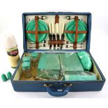 A mid 20th C picnic set with jade green Bestolite tea ware and enamelled tins, and thermos flask, in