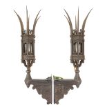 A pair of Gothic Reform wall lights, the lanterns with curved spires, and cast with lamb and flag