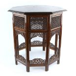 A Moorish design hardwood table, octagonal form profusely inlaid with foliate design, the supports