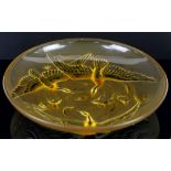 Verlys France, a large amber glass bowl with relief decoration of birds flying over water with
