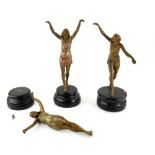 Three Art Deco period figures of dancing ladies, spelter with gilt bronze patination, on turned