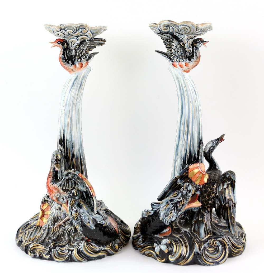 Pair of Keller & Guerin pottery candlesticks, circa 1900, each with moulded scrolling wave-like base