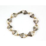 Brett Payne designer silversmith, bracelet, hand and clasp links in 9 ct gold with silver panel,