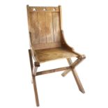 Oak gothic reform chair with trifoil pierced back rail, on X supports .