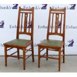 Pair of Liberty style Arts and Crafts oak chairs, the splat backs pieced with stylised tulips,