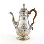 George III silver hot water jug and cover, with later embossed decoration, on round foot, maker's