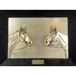 Probably German white metal presentation plaque depicting two horse heads in relief, each horse with