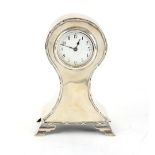 Edward VII silver balloon clock with ribbon-tie border on four ogee bracket feet, by William