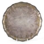 George VI silver presentation salver with shaped beaded border, on four ball and claw feet, by