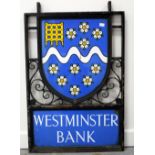 Bank sign in wrought iron with blue plaque for Westminster Bank. Overall condition good, some