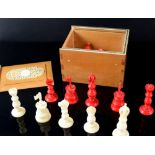 Late 19th/ early 20th century red and white ivory chess set, kings 7cm high, pawns 4cm high, in