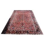 Persian red ground carpet with multiple borders the centre with repeating floral forms 380cm x 264cm