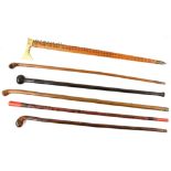 Six Eastern and African carved walking sticks and canes.
