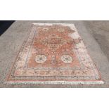Lahore Pakistan peach ground rug with multiple borders the centre with a stepped medallion 300cm x