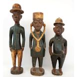 Three painted carved wooden decorated Colonial figures, possibly African, early 20th century,