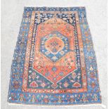 Blue ground Persian rug the central panel within a border of animals 186cm x 127cm.