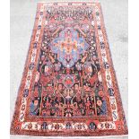Persian type red ground Rug, with multiple borders, the centre with repeating floral forms and a