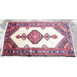 Hamadan cream ground rug with multiple borders centre with central red ground medallion, 190cm x