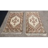Pair of Morocn cream ground rugs each 136cm x 74cm .