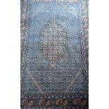 Persian blue ground rug with multiple borders the centre with shaped medallion, 158cm x 110cm .