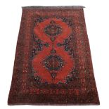 Persian type red ground rug with multiple borders the centre with two medallions, 190cm x 130cm, .