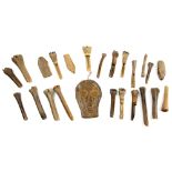 A collection of antique carved bone and horn artefacts, one modelled in the form of a skull, 14.