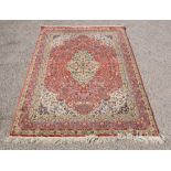 Oriental red ground rug with multiple borders and central medallion, 200cm x 125cm .