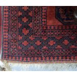 Afghan type red ground rug, 195cm x 130cm .