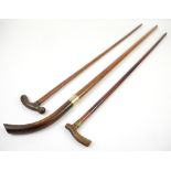 Three horn handled walking sticks .