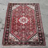 Persian type red ground rug 210cm x 120cm.