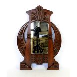 An Art Nouveau mahogany wall mirror in the style of Carlo Bugatti, tapering rectangular form with