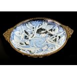 Opalescent glass dish moulded with birds and fruiting vines, gilt metal rim with twin handles,