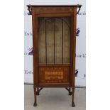 A mahogany glazed cabinet inlaid with satinwood a design of ivy leaves and floral posies, the