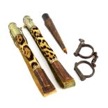 Pair of cast metal handcuffs, two early 20th century whips with animal fur handles, rosewood steak