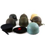 Collection of military helmets, webbing, thermos flask and other items.