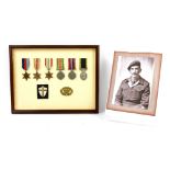 World War II group of five medals framed with a Territorial medal, Warrant Officers Class II badge