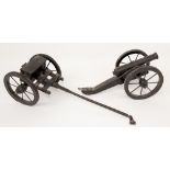 Late 19th century ebonized pine miniature gun and carriage..