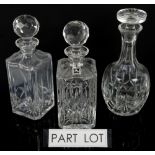 A collection of glassware including three decanters.