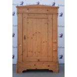 A pine cupboard of pegged construction, the interior fitted out as a wardrobe.