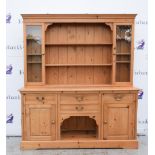 Pine dresser with glass fronted doors on top