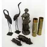 Spelter figure of a woman holding flowers, pair of spelter cranes, two pigs and two embossed shell