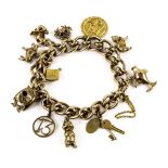 Vintage gold double link charm bracelet with twelve charms, including a cat, bull, owl, and fish