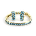 Blue topaz line bracelet, set with forty four square cut blue stones, with concealed clasp and