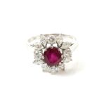 1970's cluster ring, set with central oval cut synthetic ruby, 7.0 x 6.4mm, surrounded by round